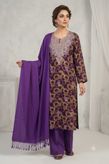 A woman models a traditional Indian salwar kameez suit set in purple and gold. The set includes a purple kurta with gold floral patterns and a matching purple dupatta, paired with solid purple trousers.