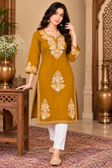 Mustard yellow kurti with cream floral embroidery around the neckline