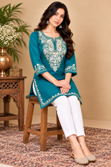 Turquoise blue kurti with cream floral embroidery around the neckline