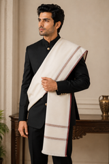 Cream colour men’s woven shawl with maroon border, worn with black traditional suit