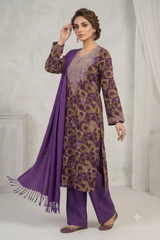 A woman models a traditional Indian outfit consisting of a purple and brown patterned kurta, matching purple trousers, and a purple dupatta with fringe, set against a neutral studio backdrop.