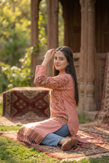 Pink woolen kurti with traditional Kashmiri embroidery worn by a model